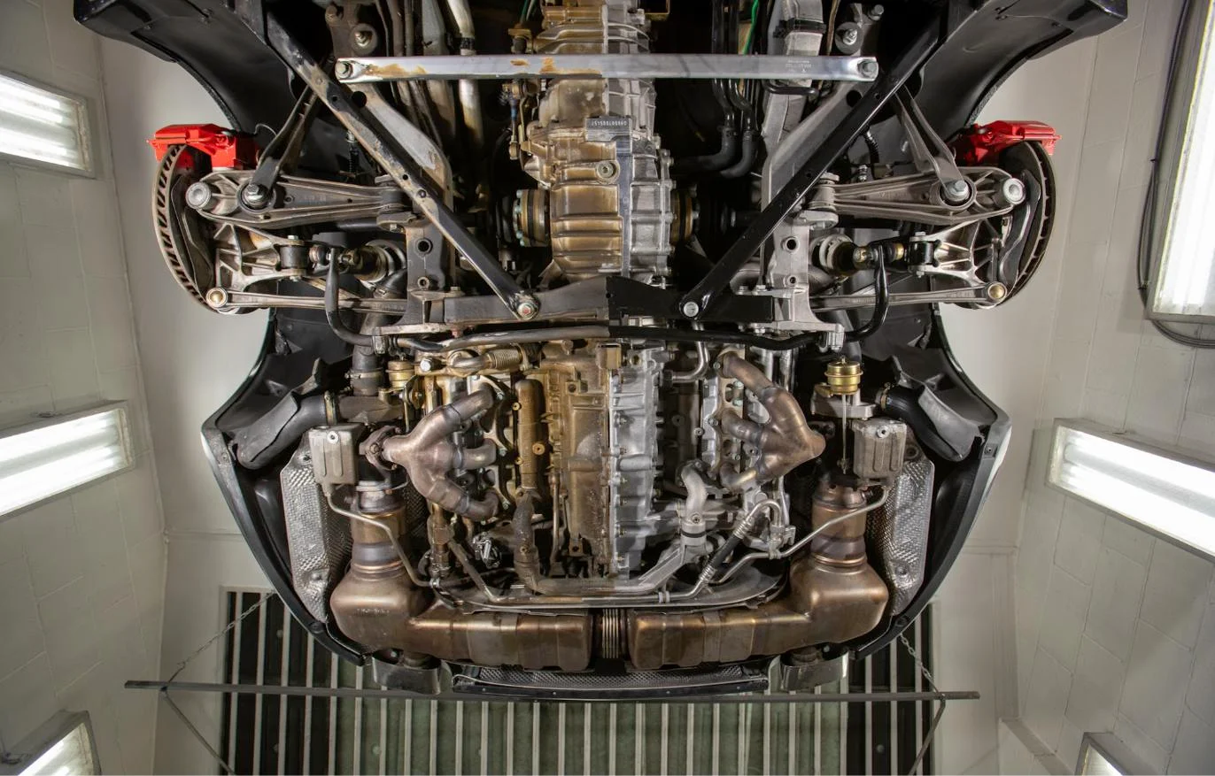 Undercarriage of a Porsche 911 photographed on the lift at Reimel Motor Cars